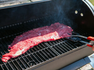 Bavette on the grill, barbecue bavette in the garden close up, grilled beef outdoors in the summer food concept