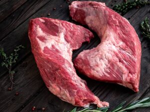 raw beef tri tip steak for BBQ on wooden background, top view